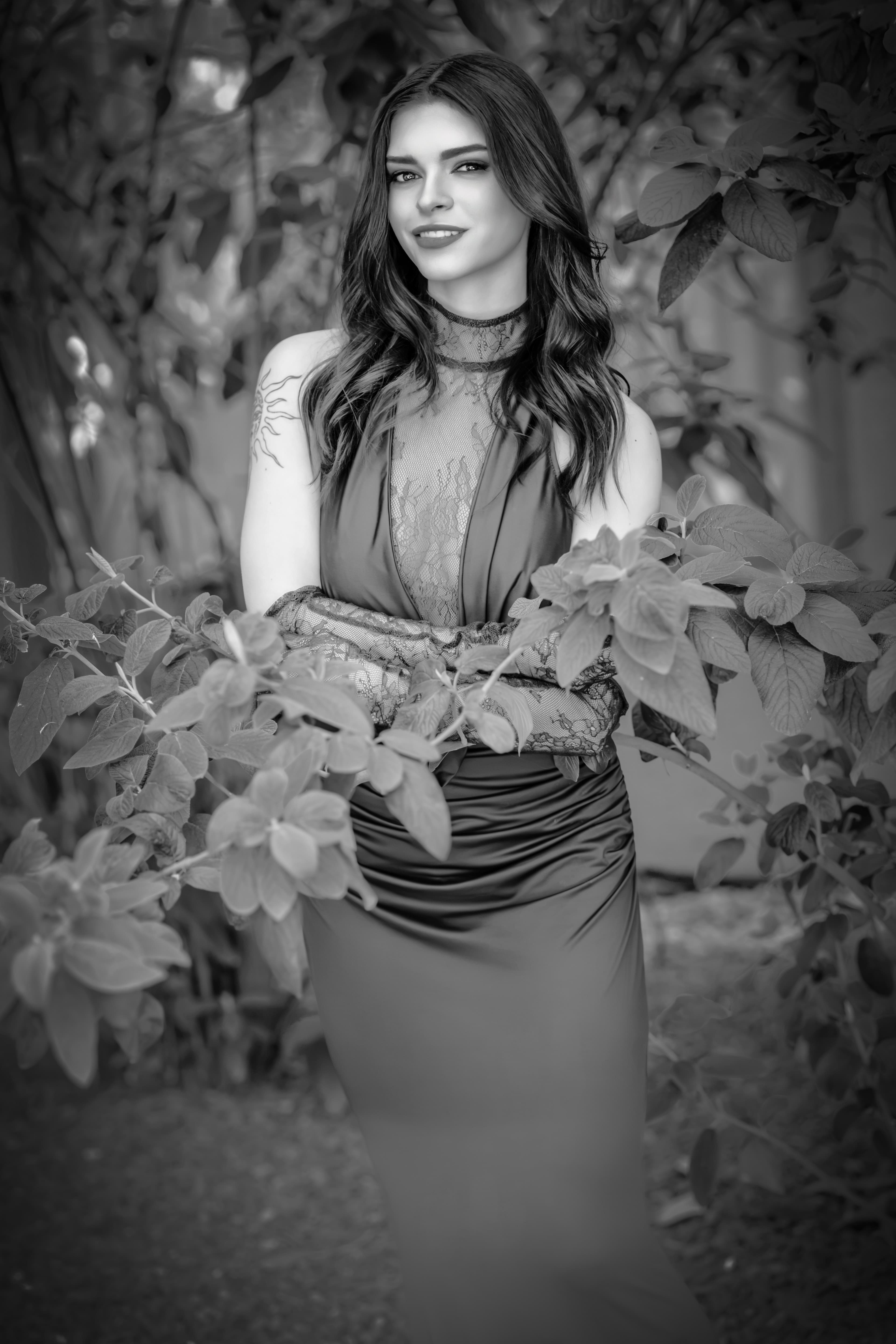 Black and white portrait photographed at Shutterfest 2026, framed by foliage