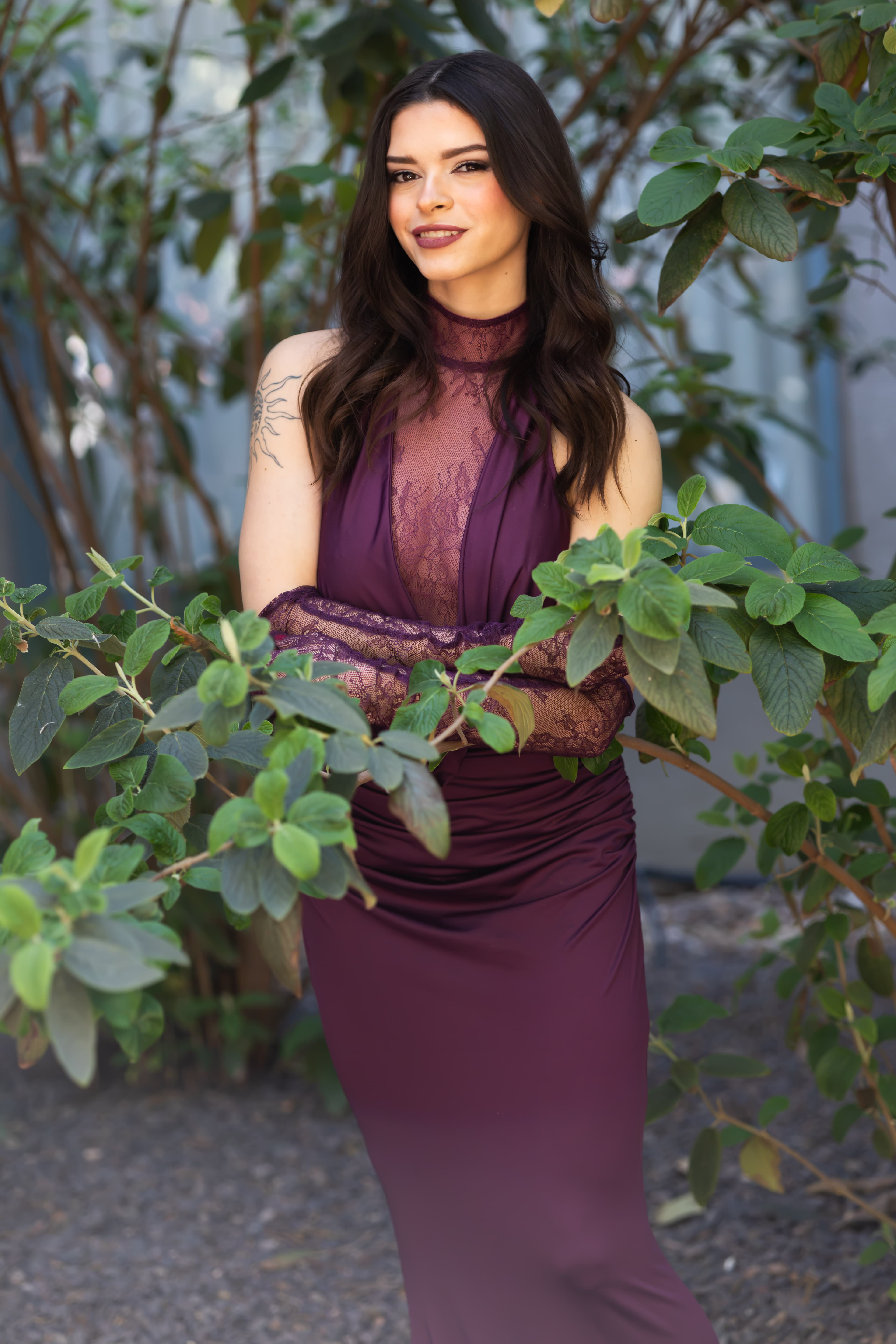 Original color portrait photographed at Shutterfest 2026 with burgundy dress and green foliage