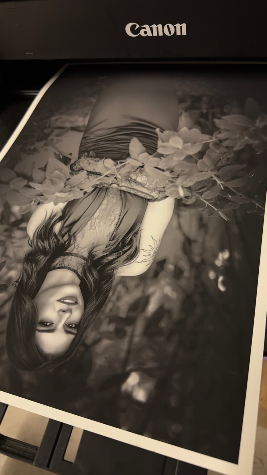 Black and white portrait emerging as a physical photographic print