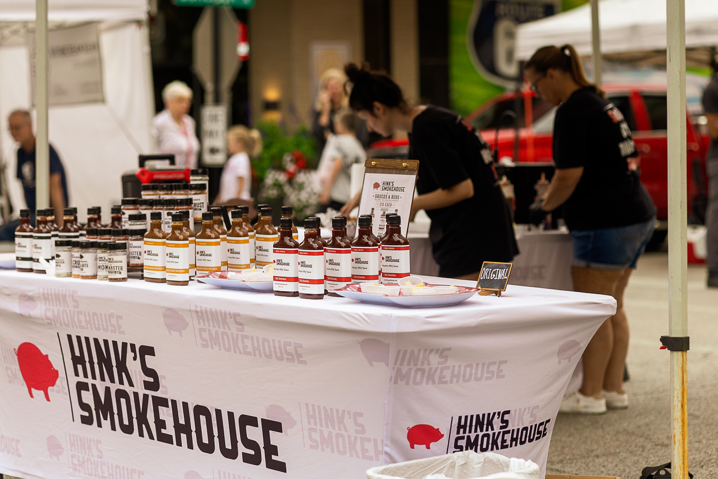 Hink’s Smokehouse sauces arranged across a vendor table at the Downtown Bloomington Farmers’ Market.